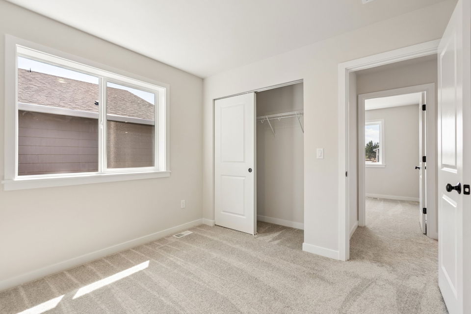 A room with white walls and a window.