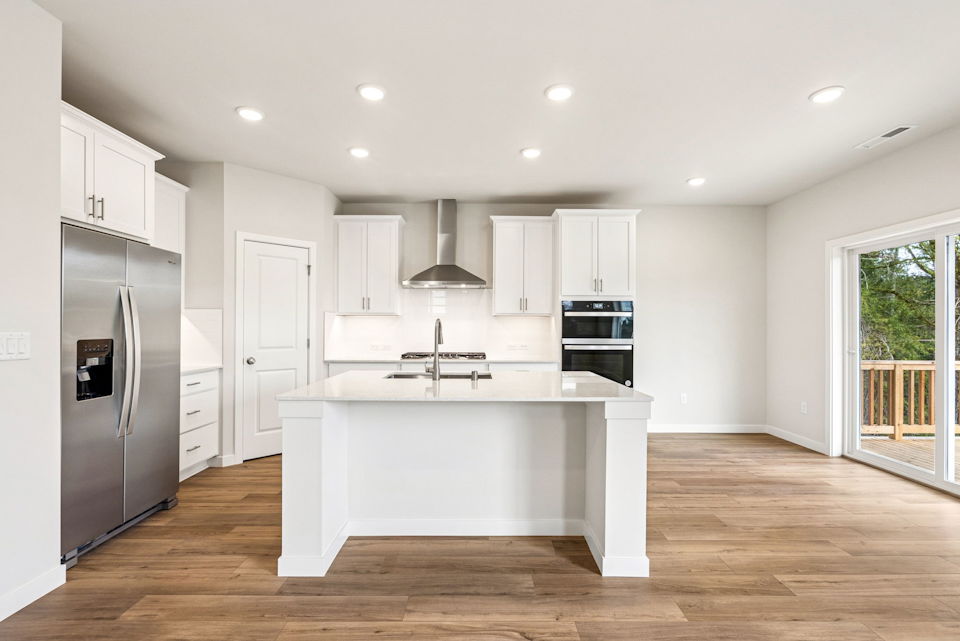 A kitchen with white cabinets.