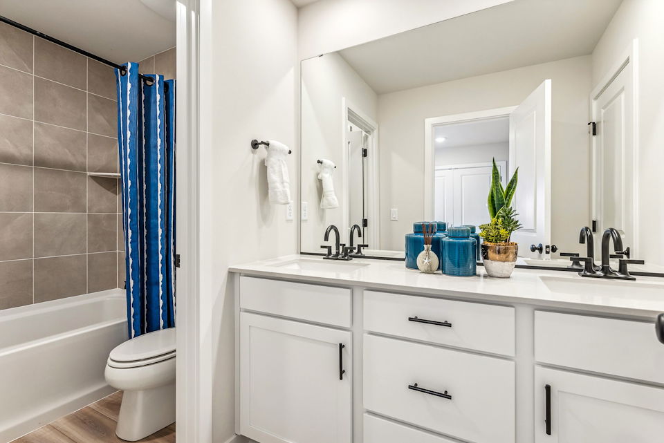 A bathroom with a tub sink and toilet.