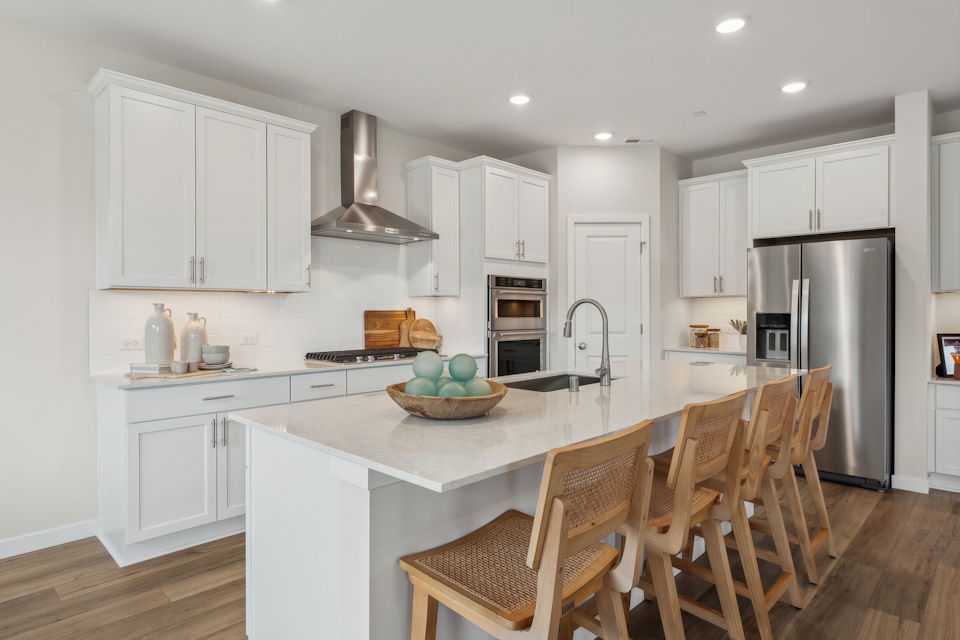 A kitchen with white cabinets.