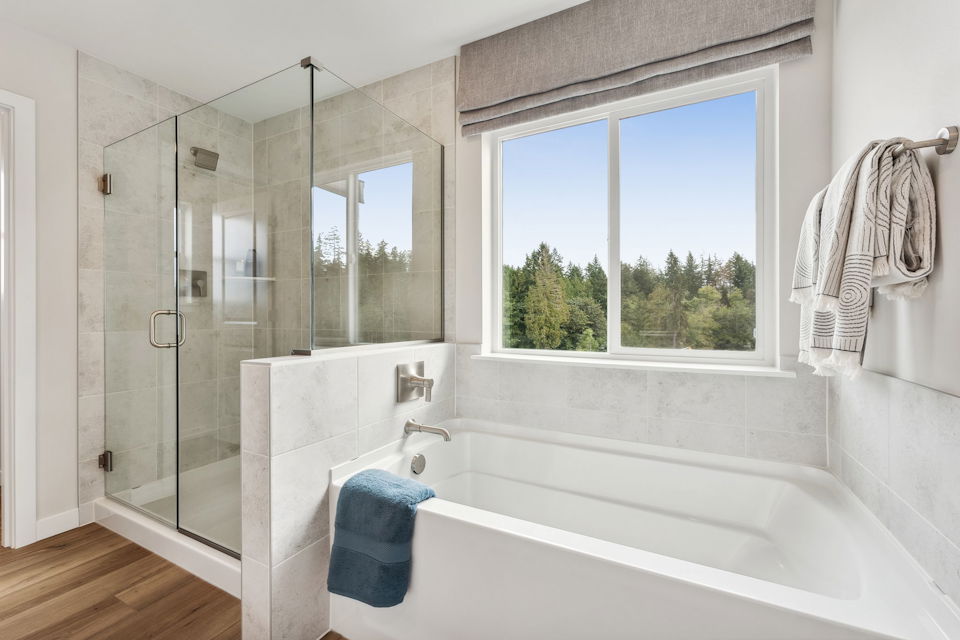 A bathroom with a tub and a window.
