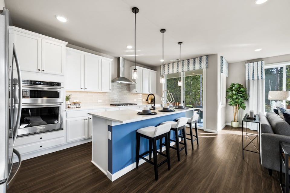 A kitchen with white cabinets.
