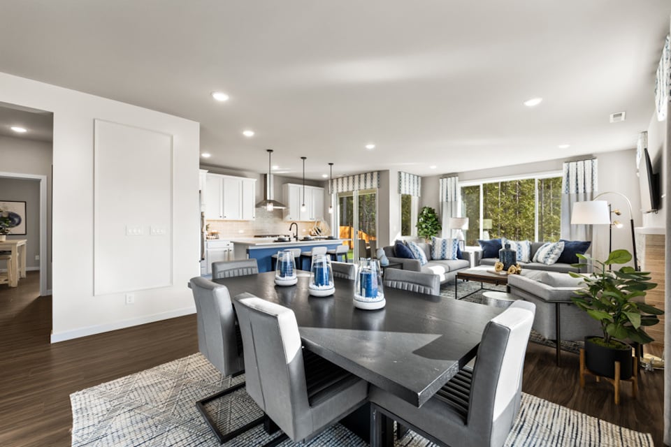 A large living room with a dining table and chairs.