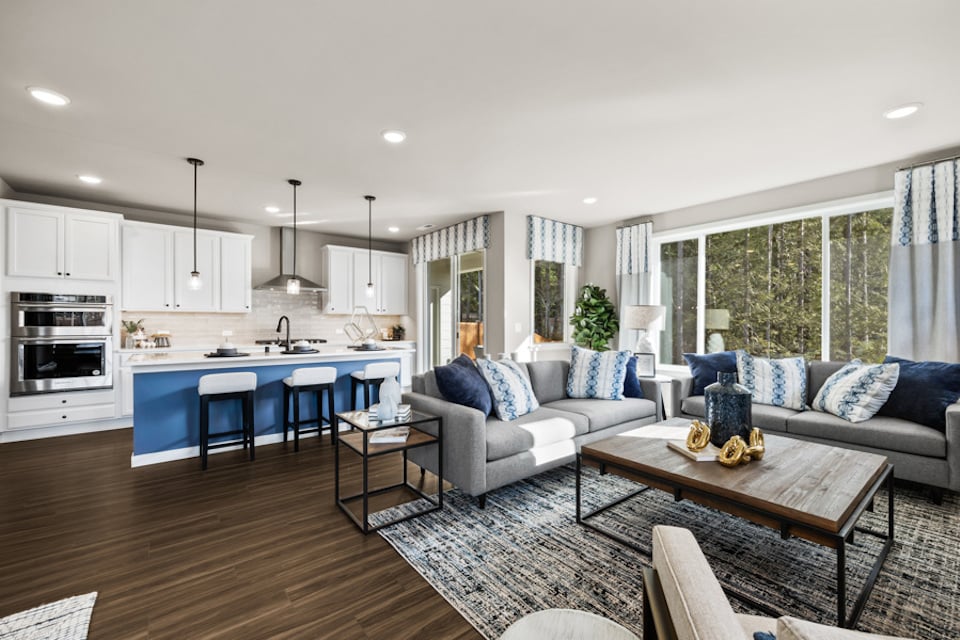 A large living room with a large kitchen and a large island.