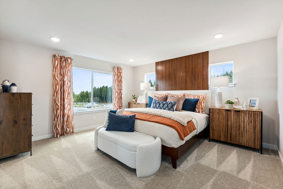 A large bedroom with a large window.