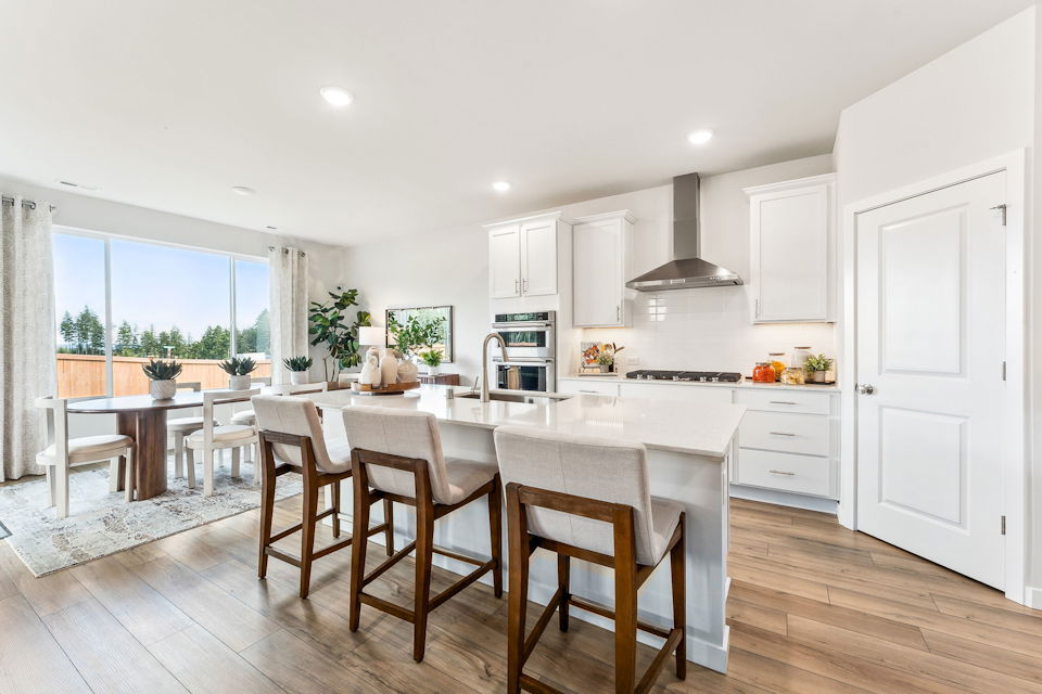 A kitchen with white cabinets.