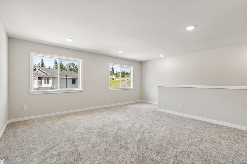 A room with a carpet and a window.
