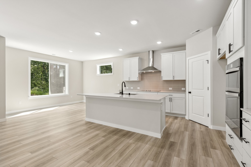 A kitchen with white cabinets.