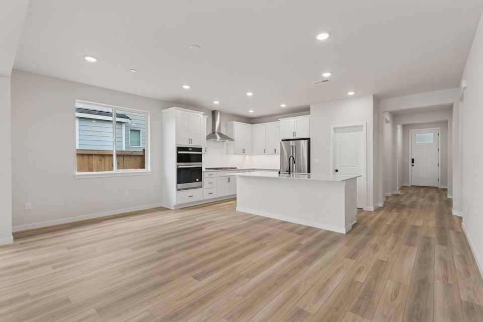 A kitchen with white cabinets.