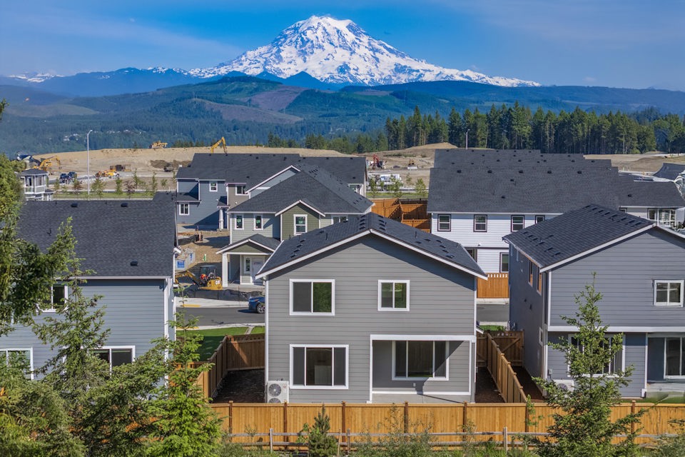 A group of houses with a mountain in the background.