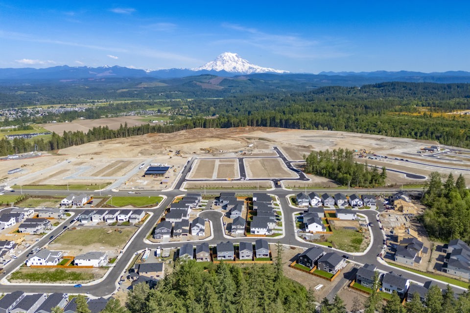 A large parking lot with a mountain in the background.