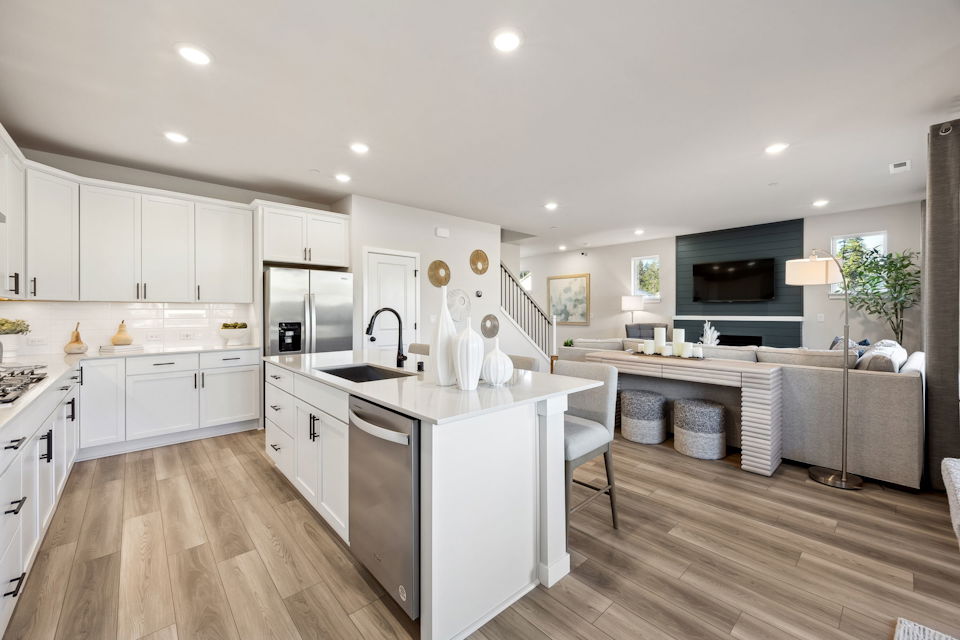 A kitchen with white cabinets.