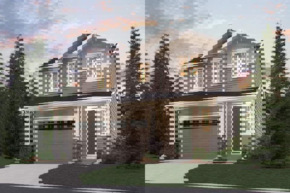 A house with a garage and trees around it.