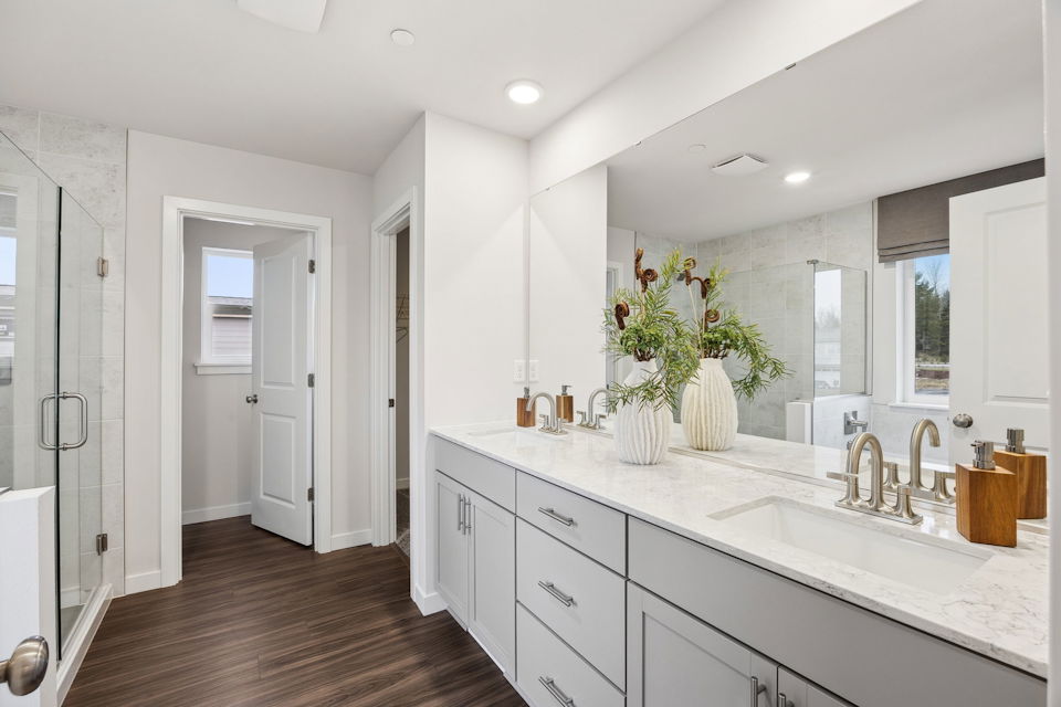 A bathroom with white cabinets.