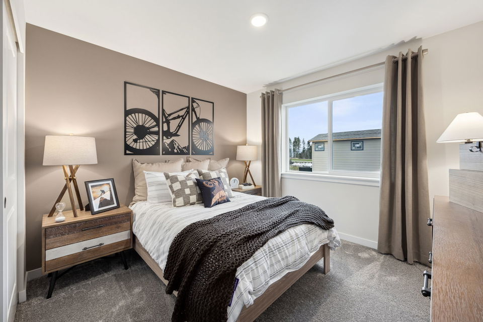 A bedroom with a large window.