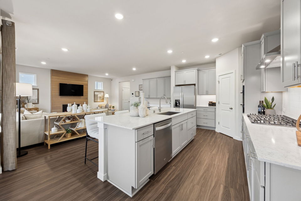 A kitchen with white cabinets.