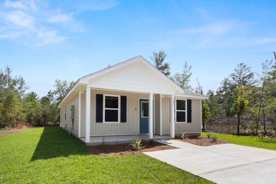 A white house with a driveway.