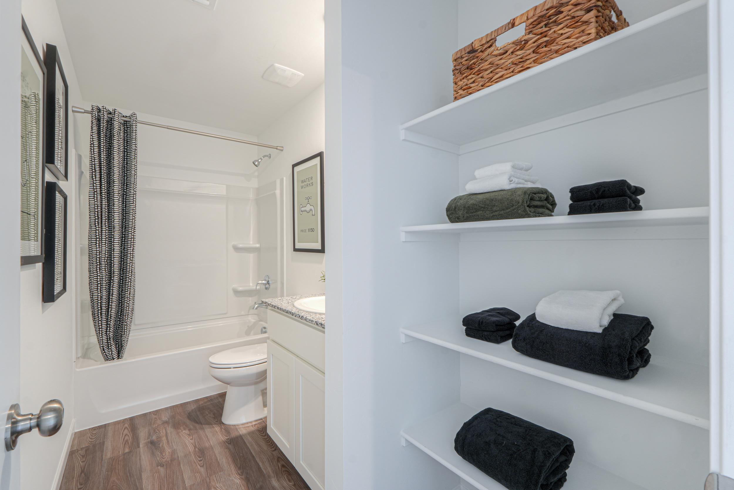 A bathroom with a shelf and a toilet.