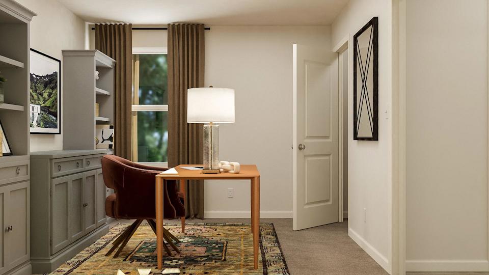 A room with a desk and a chair.