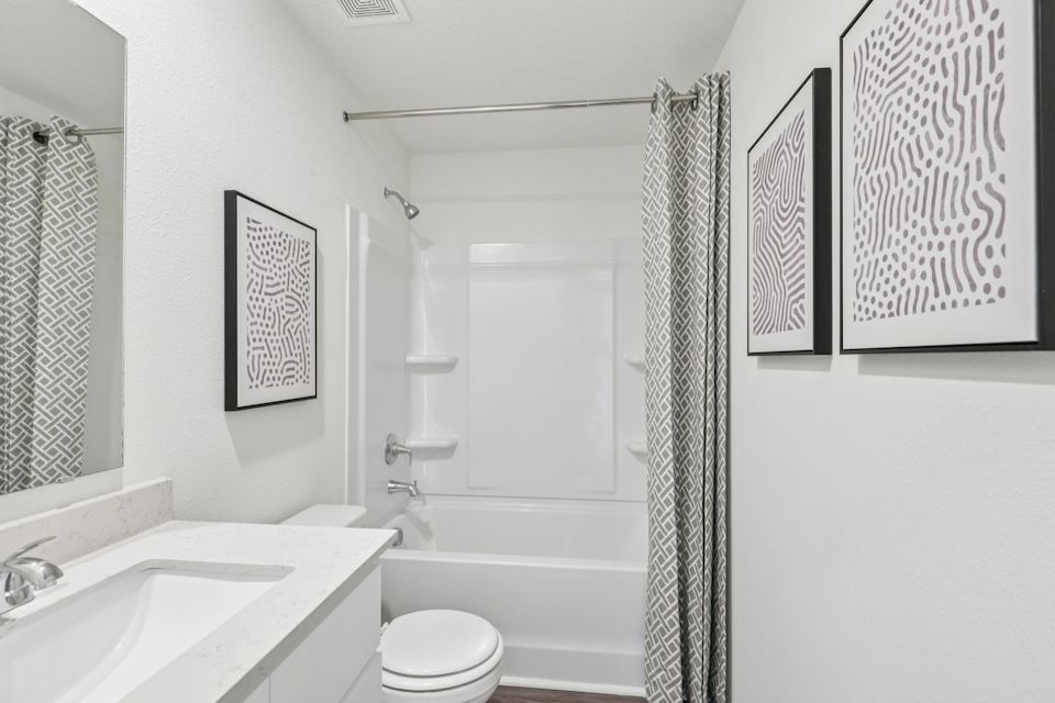 A bathroom with a shower and sink.