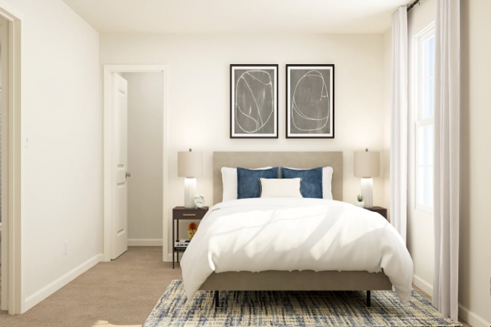 A bedroom with a bed and lamps.