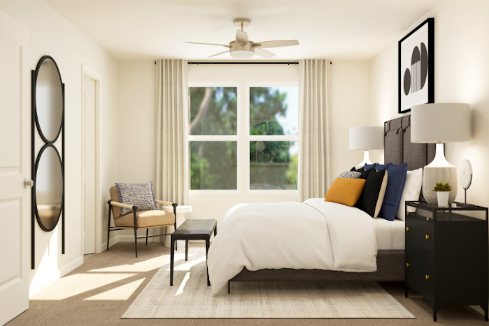 A bedroom with a bed and a fan.