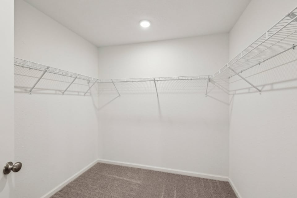 A white room with a carpet.