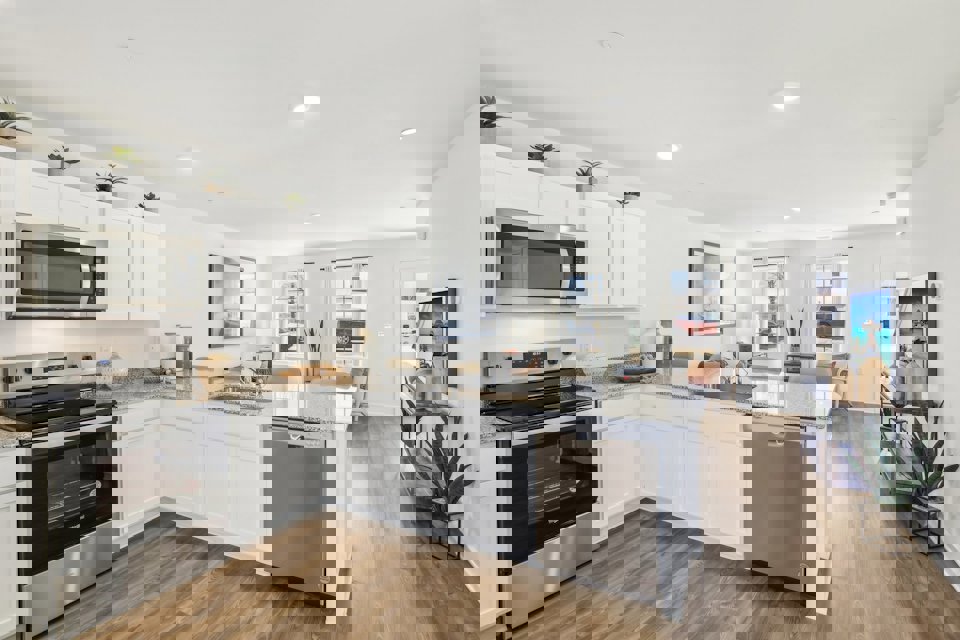 A kitchen with white cabinets.