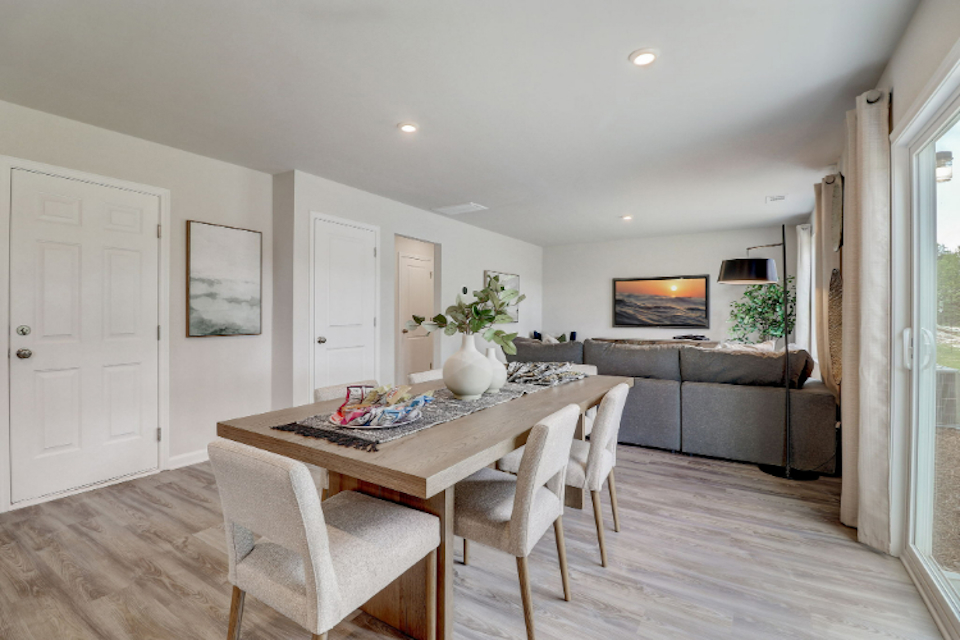 A dining room with a couch and chairs.