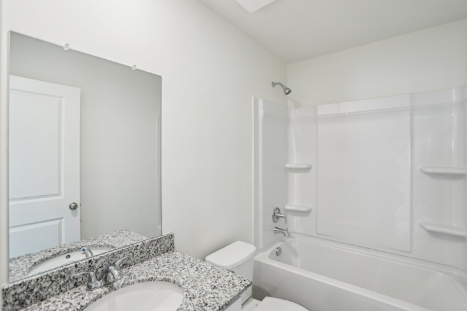 A bathroom with a marble countertop.