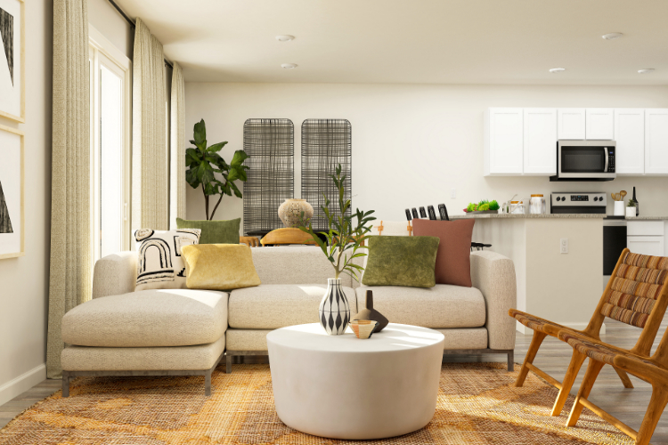 A living room with a white couch and a white table.