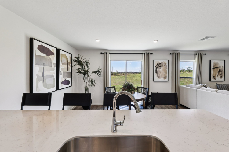A kitchen with a large window.