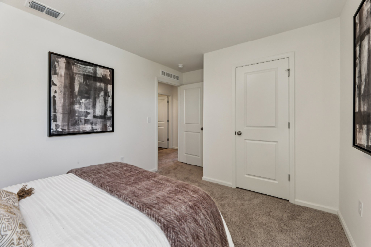 A bedroom with a bed and a door.