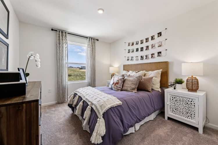 A bedroom with a large window.
