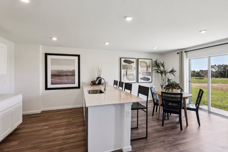A kitchen with a dining table.