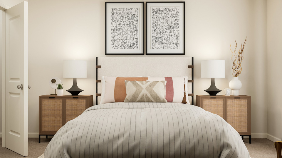 A bed with a white wall.