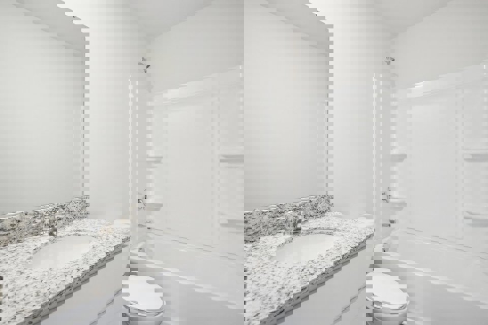 A bathroom with a marble countertop.