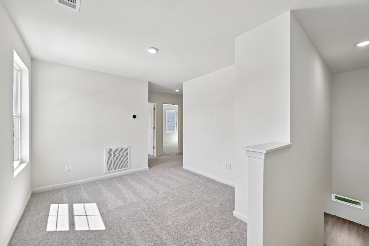 A hallway with white walls.