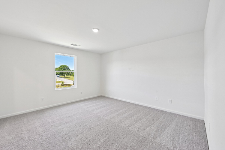 A room with a painting on the wall.