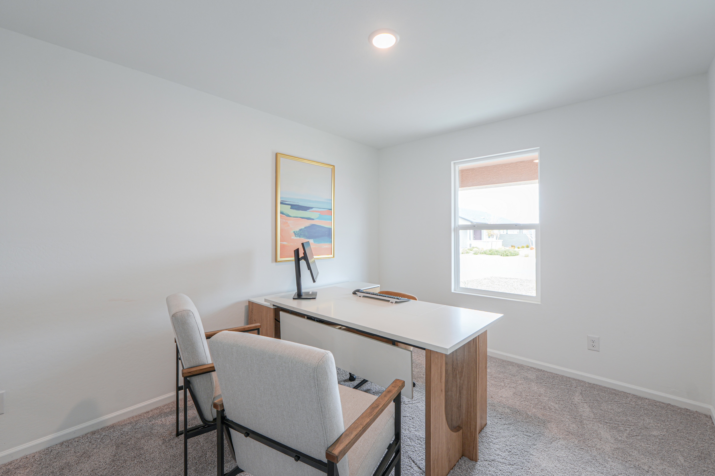 A room with a desk and chairs.