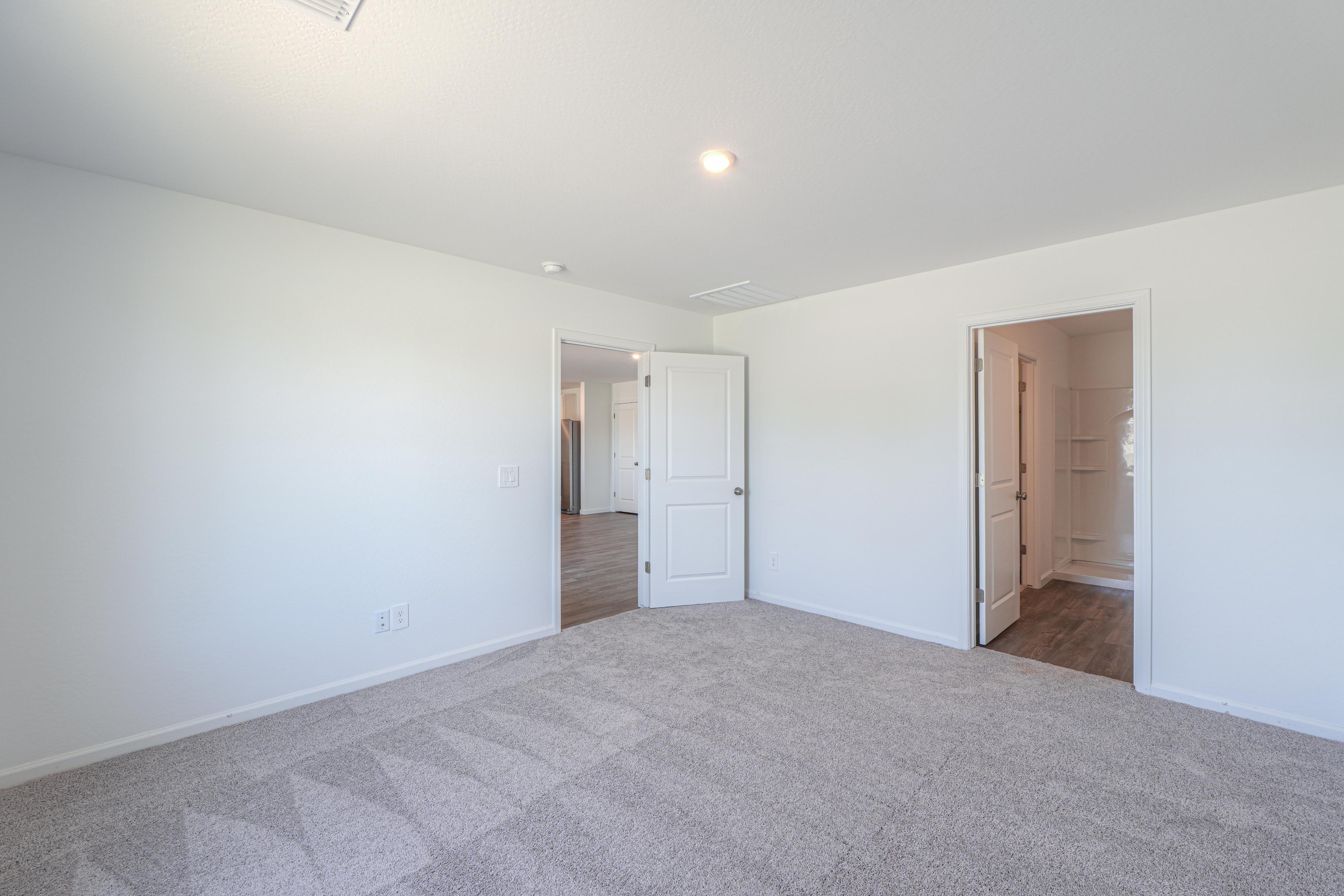 A hallway with white walls.