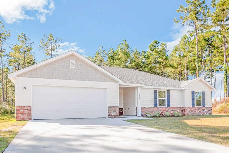 A house with garages and trees.