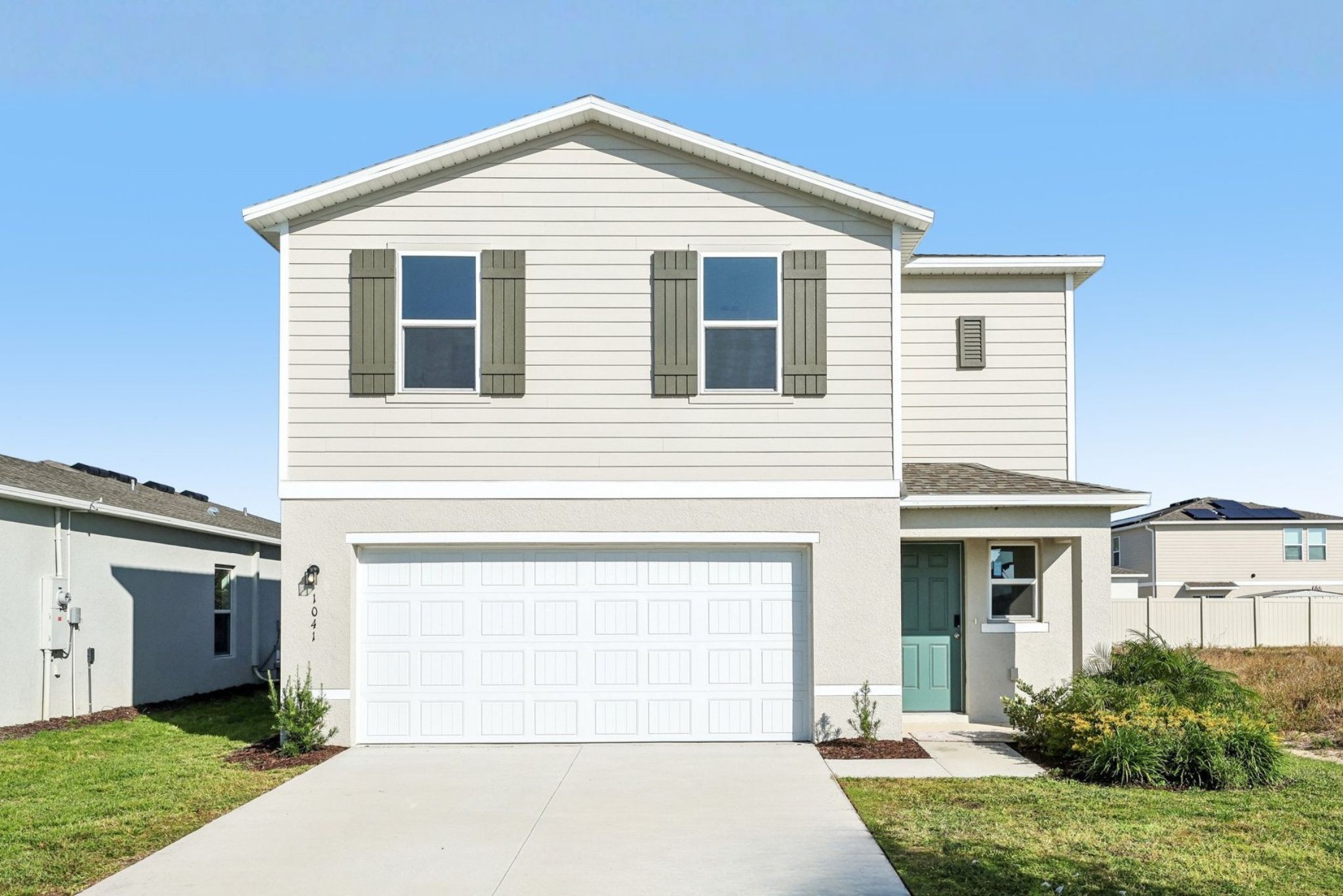 A white house with a garage.