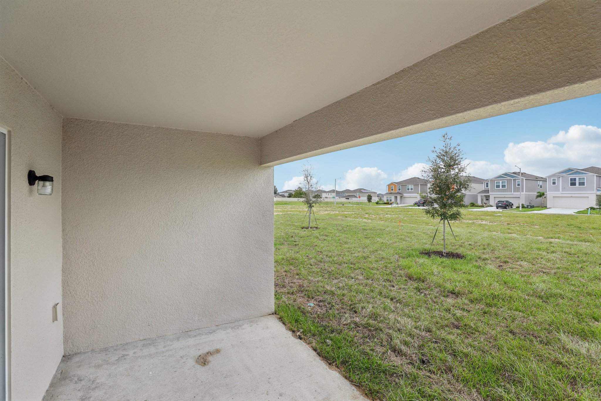 A view of a grass yard and some buildings.