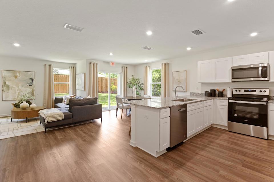 A large kitchen with a couch and a table.
