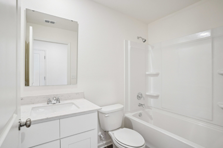 A bathroom with a toilet and sink.
