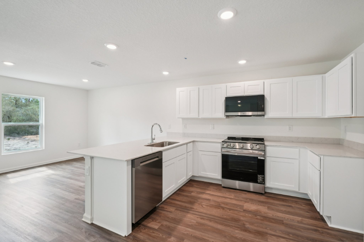 A kitchen with white cabinets.