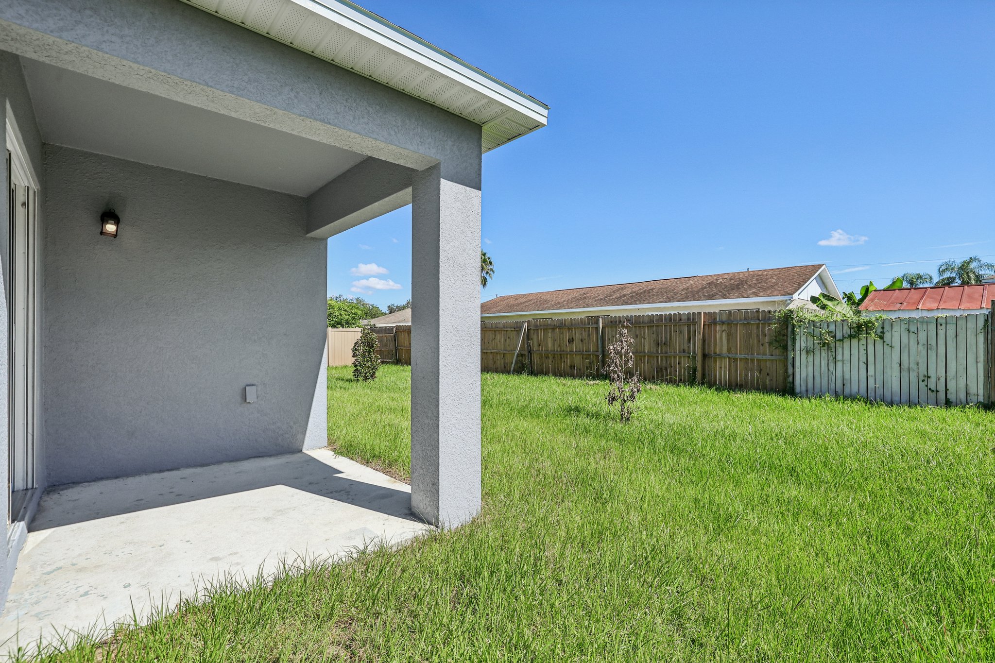 A house with a fence and grass.