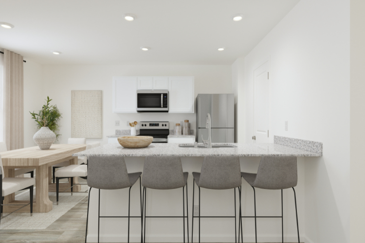 A kitchen with a table and chairs.