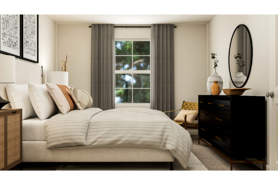 A bedroom with a bed and a mirror.